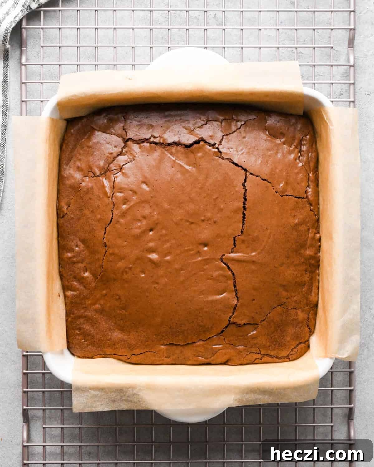 brownies in a parchment lined baking dish after baking
