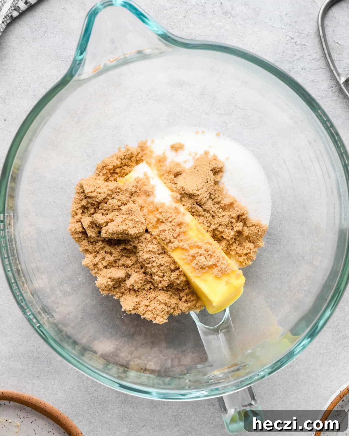making cookie dough brownies - butter, white sugar and brown sugar in a nixing bowl before mixing. 