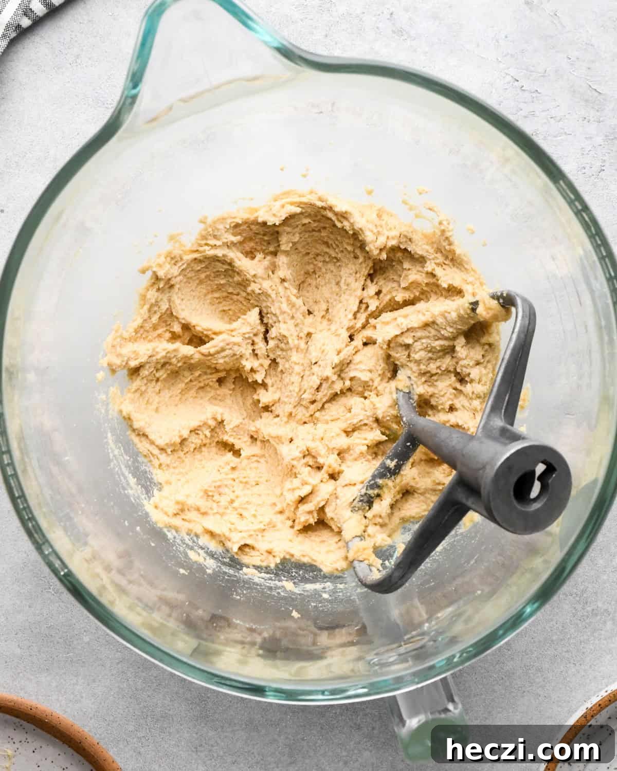 making cookie dough brownies - butter-sugars mixture in a glass mixing bowl after beating with the paddle attachment in the bowl