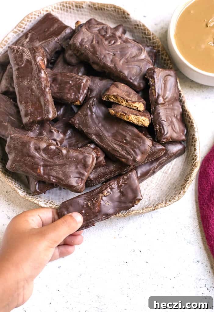 a little hand grabbing a paleo vegan Butterfinger candy bar