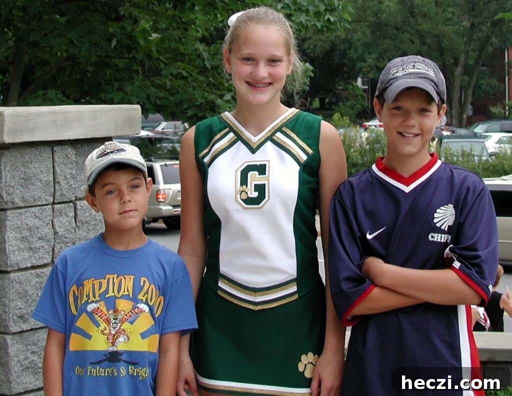 Three kids standing on a patio.