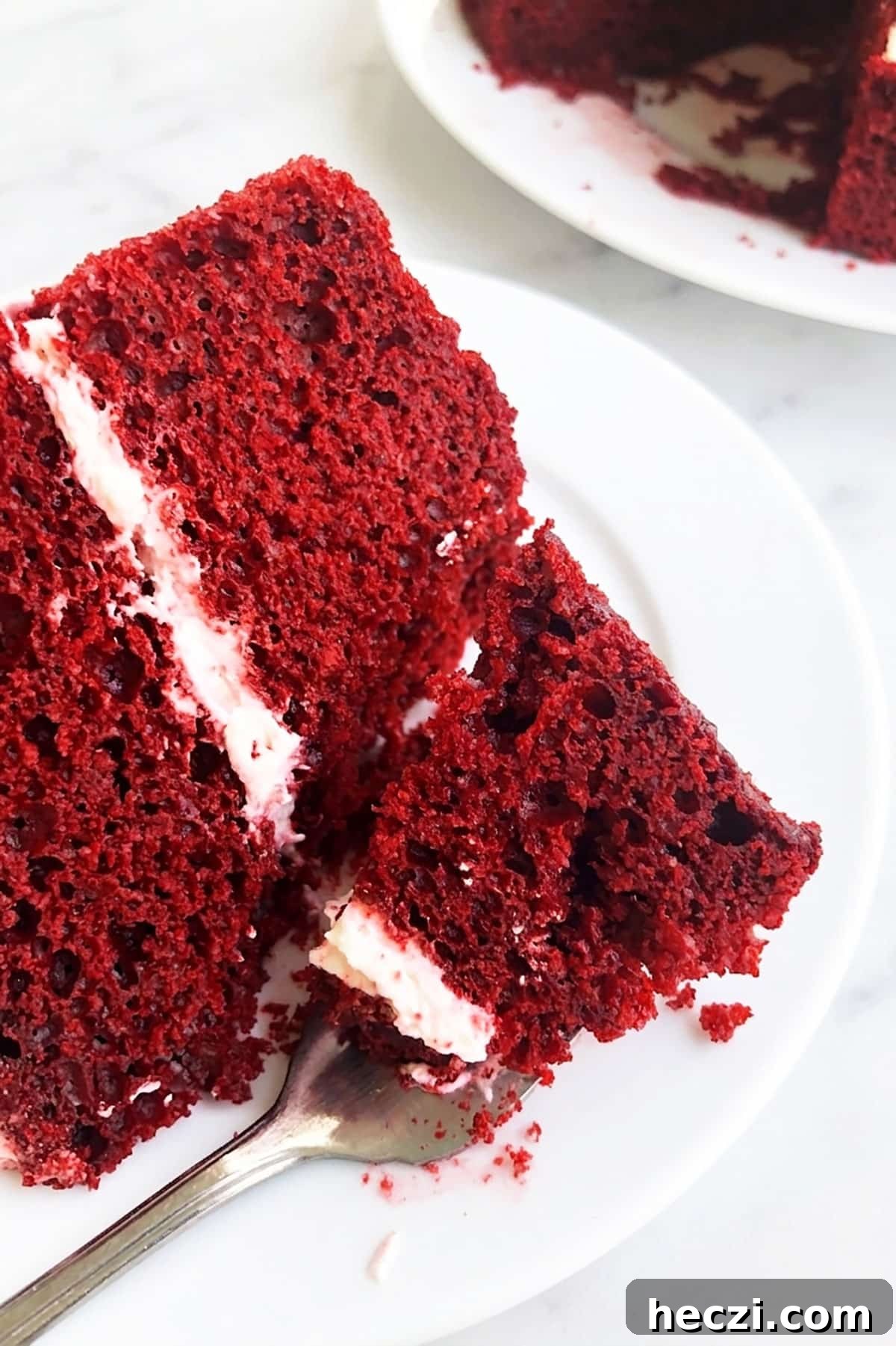 Moist Red Velvet Layer Cake Recipe for Perfect Celebrations 5 Spoonful of Cake on White Dish.