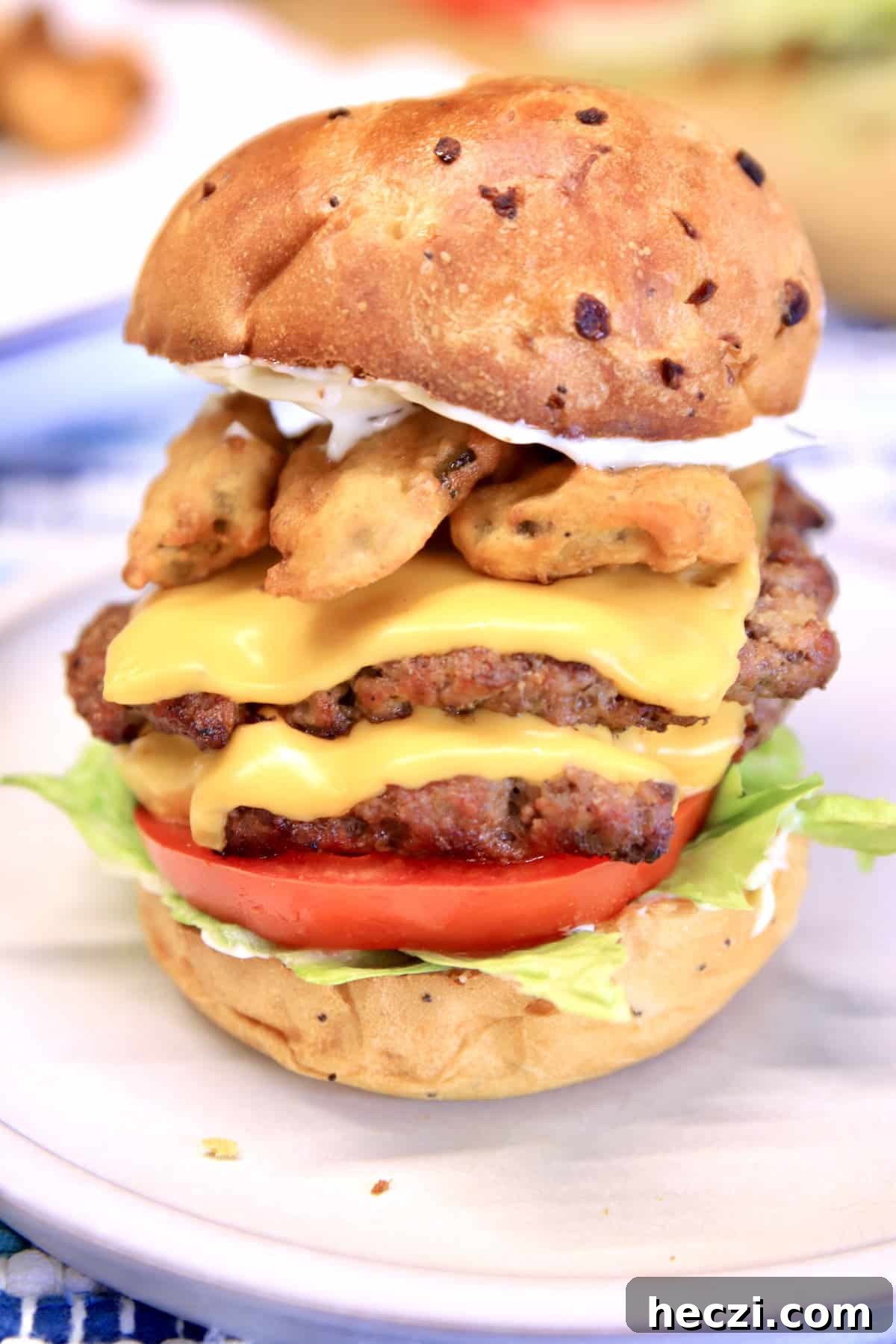 Double cheeseburger with fried pickles on an onion bun.
