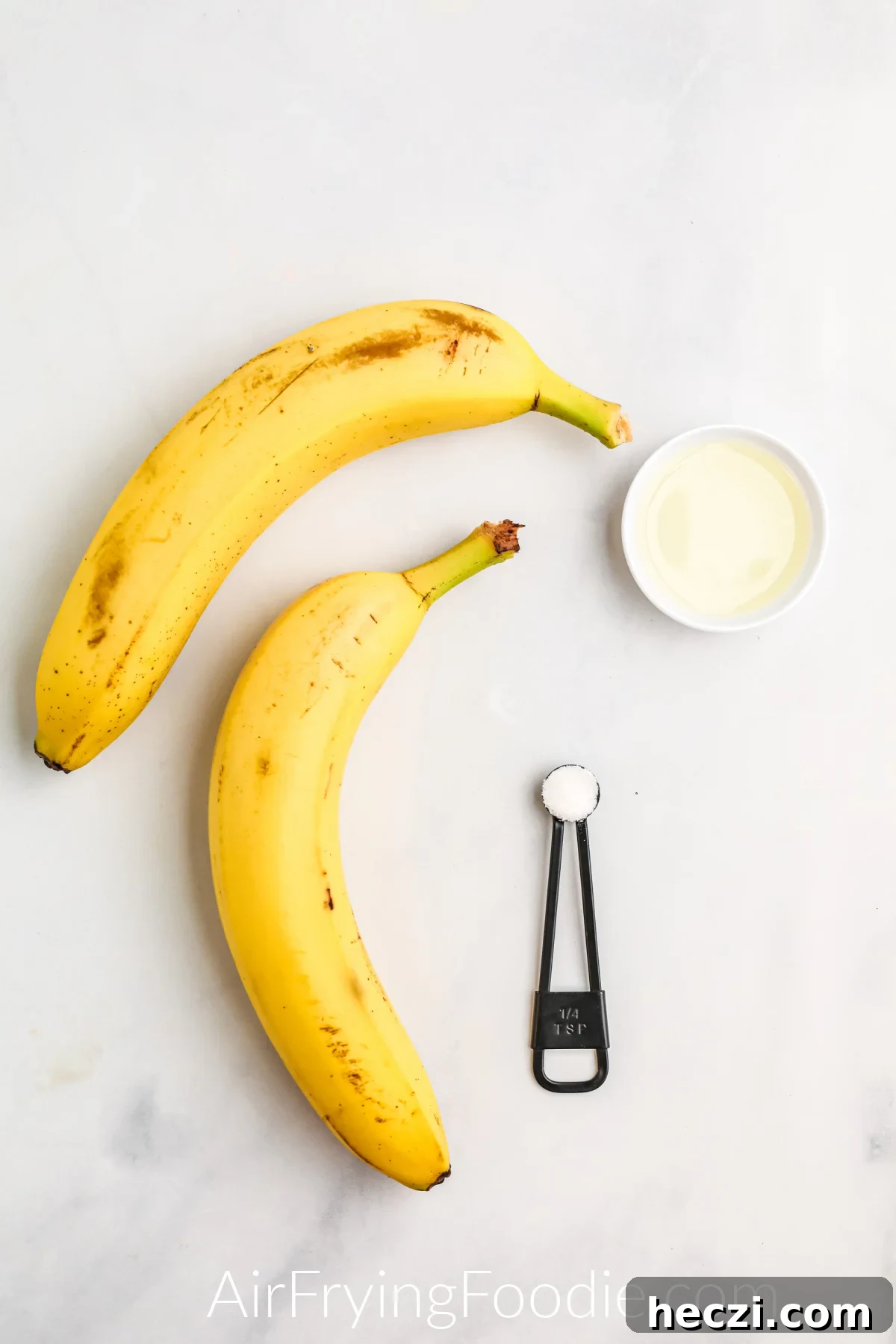 Crispy Air Fryer Banana Chips Recipe — Quick Snack at Home 4 Ingredients needed to make banana chips in the air fryer - bananas, kosher salt, and olive oil