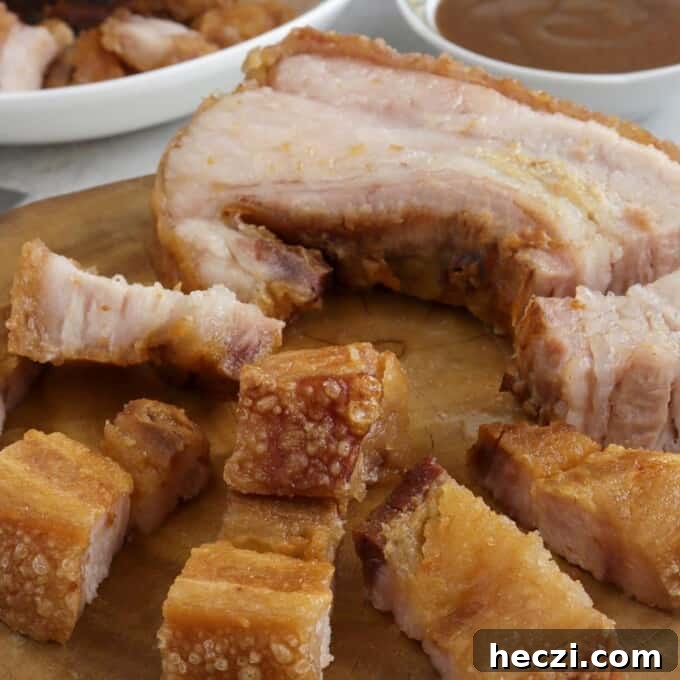 crispy pork belly on a wooden chopping board
