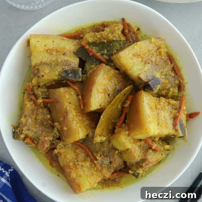 Adobong Dilaw: Filipino Yellow Adobo Recipe with Turmeric and Coconut Milk 7 yellow adobo in a white serving bowl