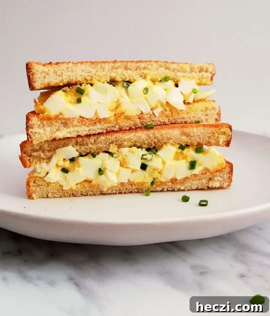 egg salad sandwich sliced in half and stacked