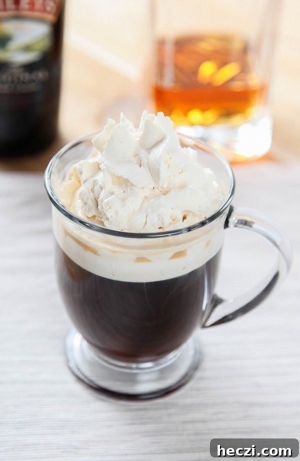 irish coffee in a mug topped with Bailey's Whipped Cream.