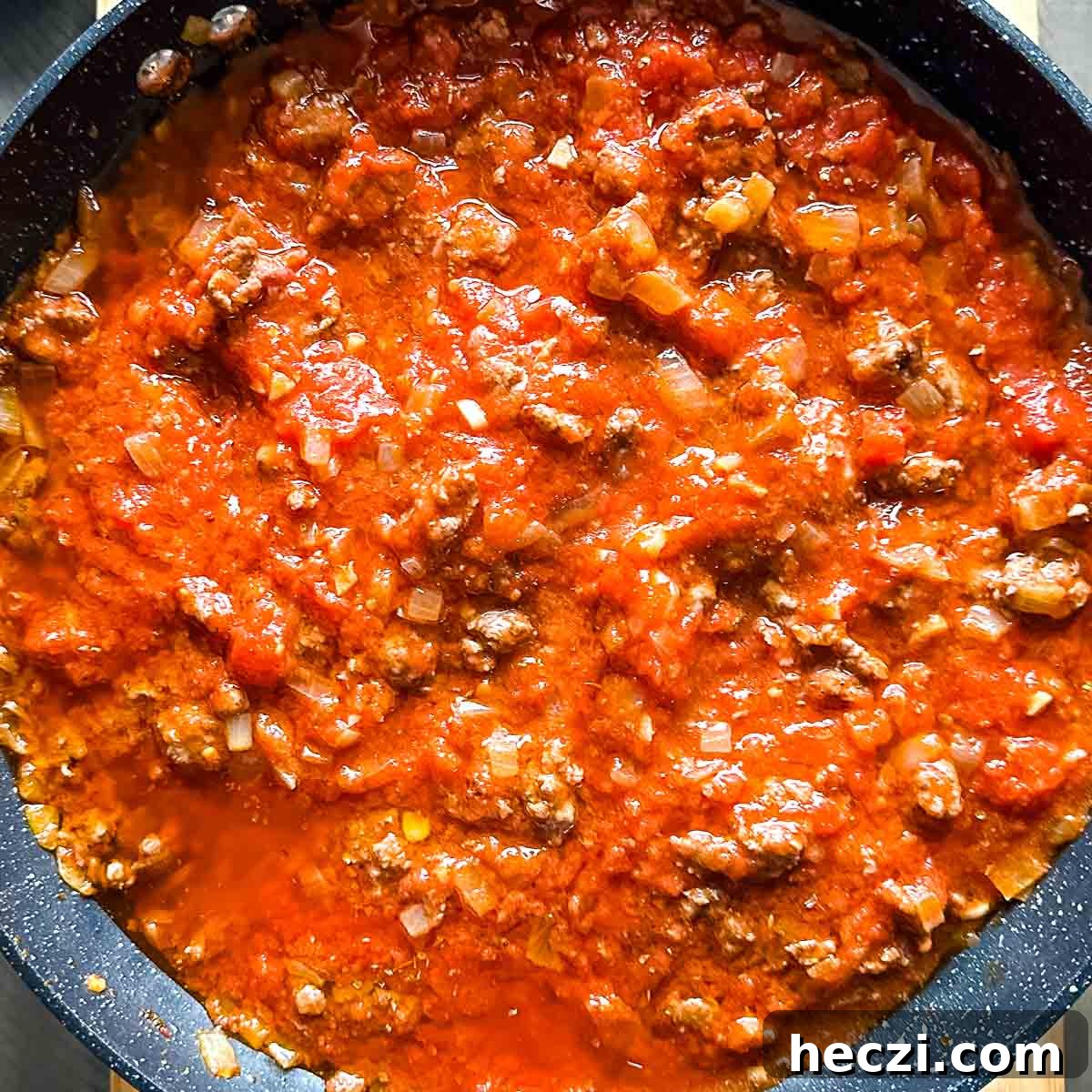 Slow Cooker Lamb Ragu: Tender Rustic Pasta Sauce Recipe 13 lamb ragu in a gray pan.