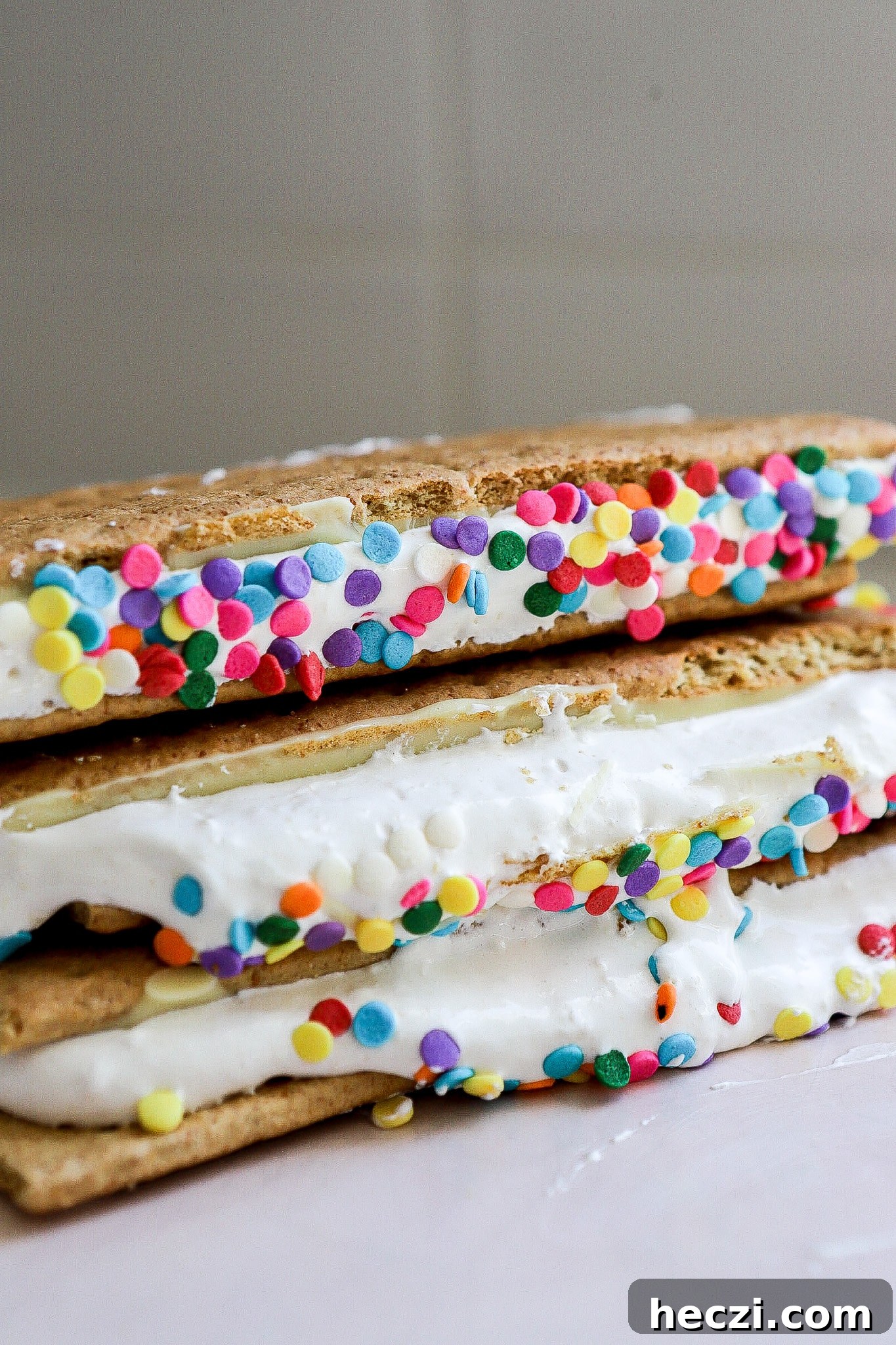 Side view of viral frozen protein s'mores with rainbow sprinkles in white kitchen.