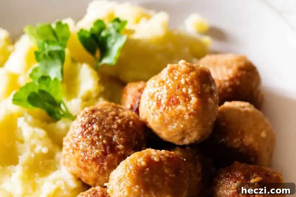 Italian meatballs on a plate with mashed potatoes.