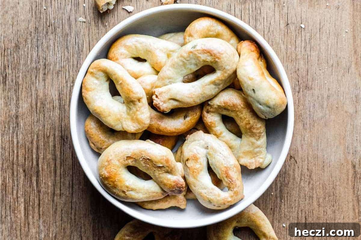A white bowl of appetizers on a wooden table.