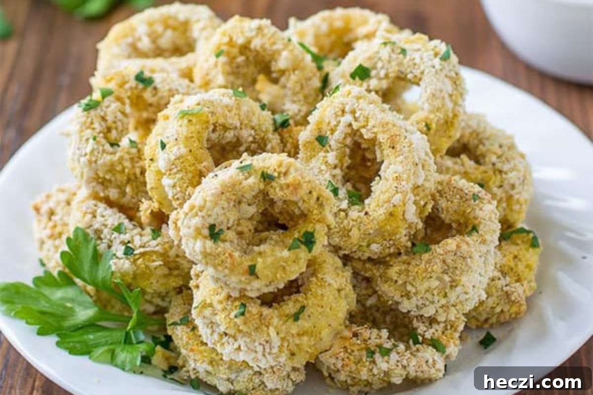 Crispy fried calamari served as appetizers on a white plate.