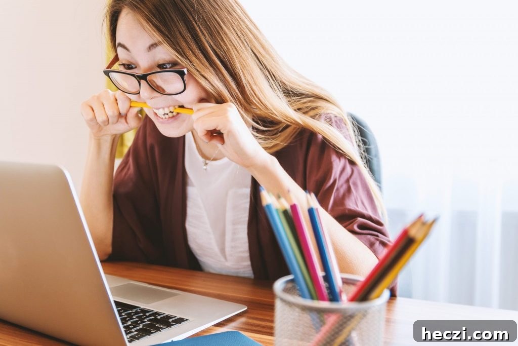 woman at computer biting pencil for genealogy mistake