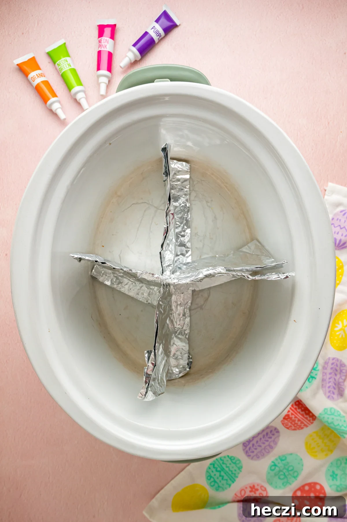 Aluminum foil in a slow cooker to create sections.