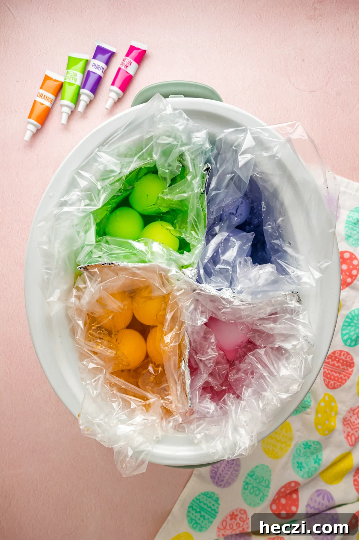 Colored easter eggs in a crockpot before cooking.