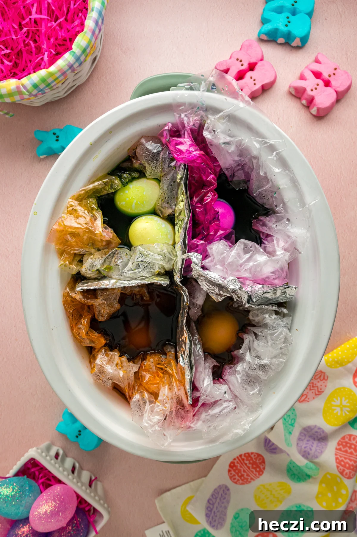 Colored easter eggs in a crockpot after cooking.