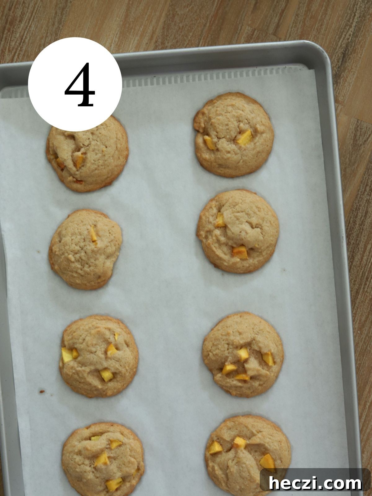 Peach Cobbler Cookies Recipe: Soft Peach Jam-Filled Cookies 7 Freshly baked peach cobbler cookies on a baking sheet.