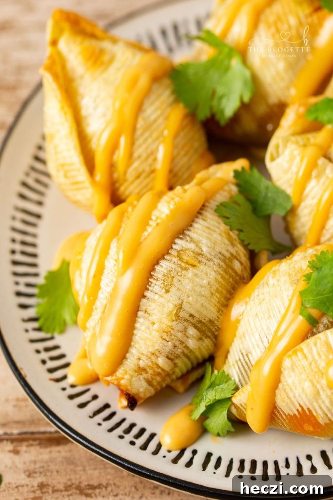 Air Fryer Taco Stuffed Shells recipe features seasoned ground beef and ooey-gooey cheese melted inside of slightly crisp air-fried shells.