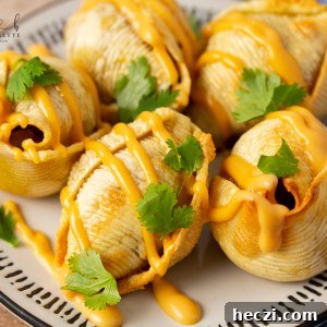 Air Fryer Taco Stuffed Shells recipe features seasoned ground beef and ooey-gooey cheese melted inside of slightly crips air-fried shells.
