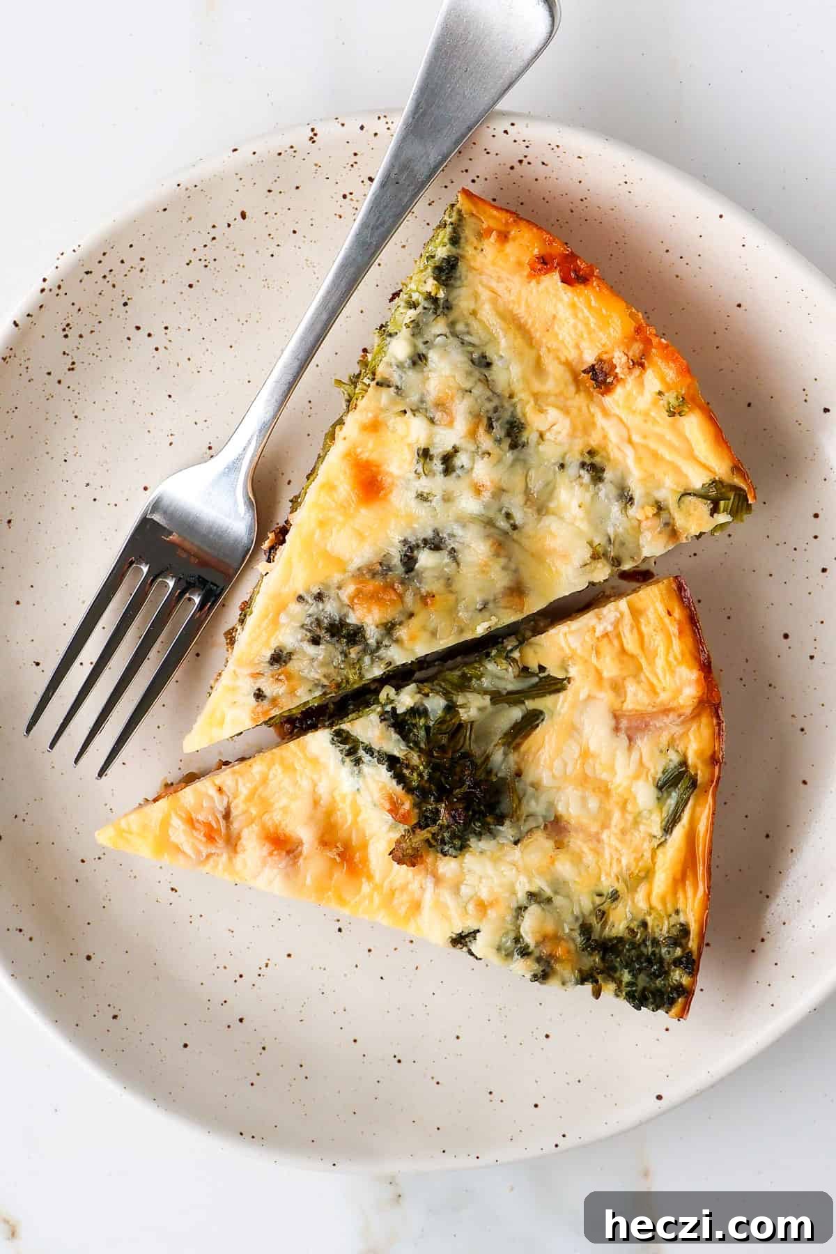 Ham and Broccolini Frittata Recipe for Brunch or Dinner 12 Two slices of broccolini frittata on a plate.