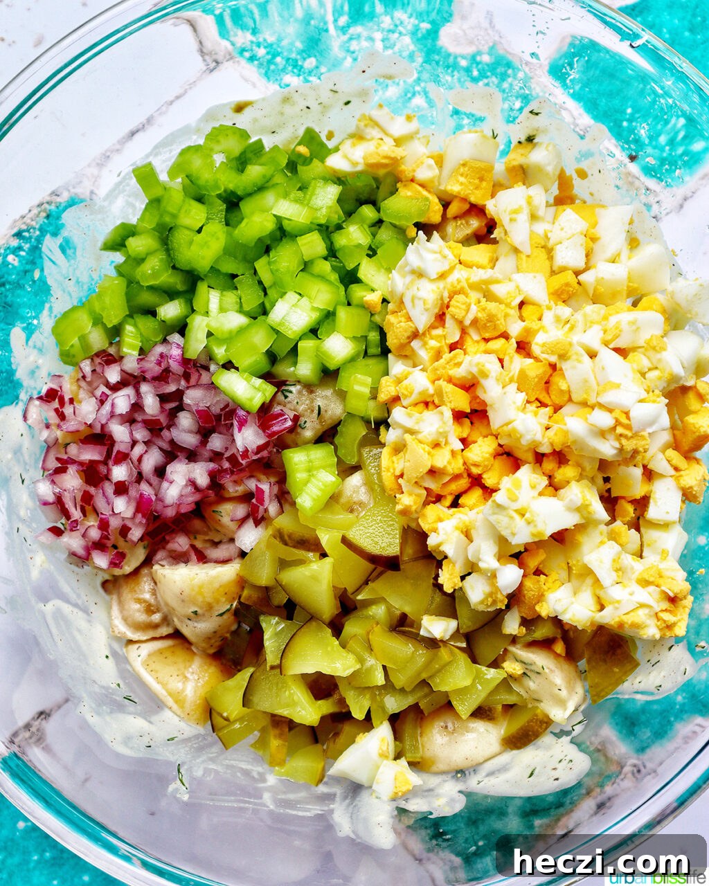 Creamy Dill Pickle Potato Salad Recipe 11 ingredients to make dill pickle potato salad in a bowl.