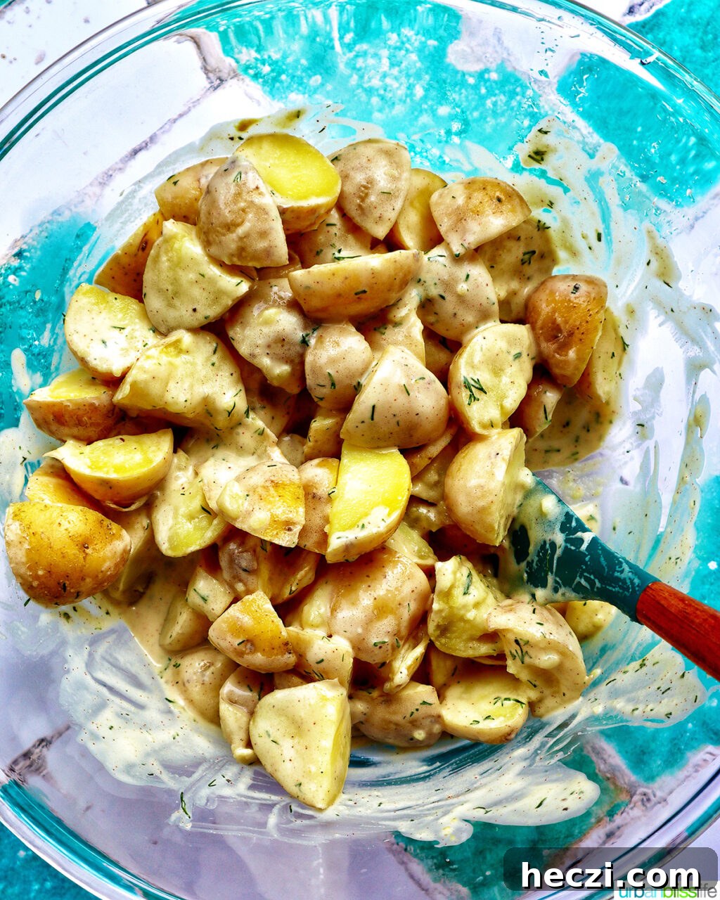 Creamy Dill Pickle Potato Salad Recipe 10 potatoes with dressing in a bowl.