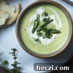 Smooth and creamy cold asparagus bisque is a recipe you'll want to make all year long! This classic French soup is easy to make, takes only a handful of ingredients, and comes together quickly. Perfect as a first course or as a vegetarian main. | justalittlebitofbacon.com