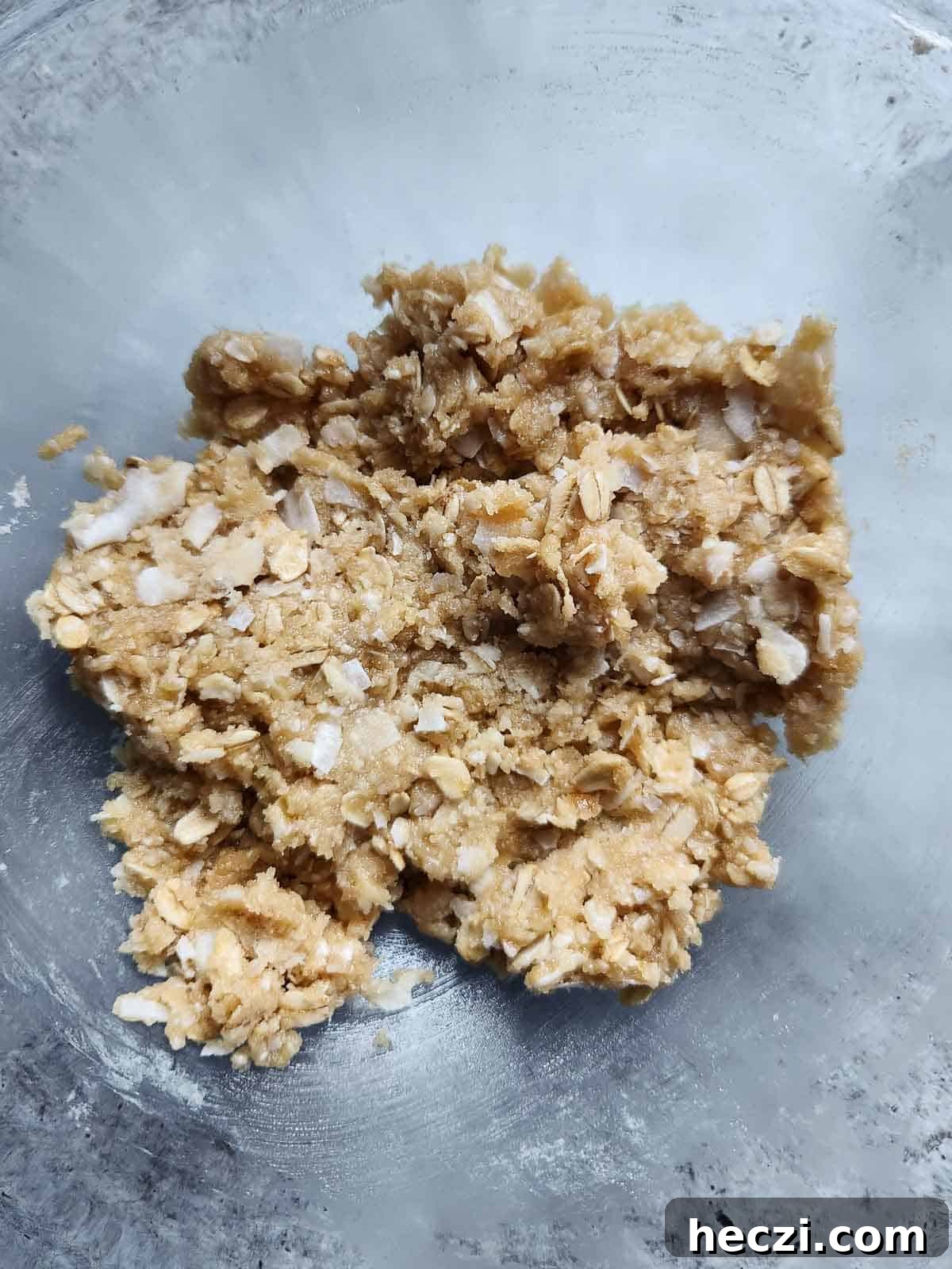 Coconut Oatmeal Cookie Recipe — Chewy Coconut Oatmeal Cookies 5 Batter for coconut oatmeal cookies in a clear bowl.