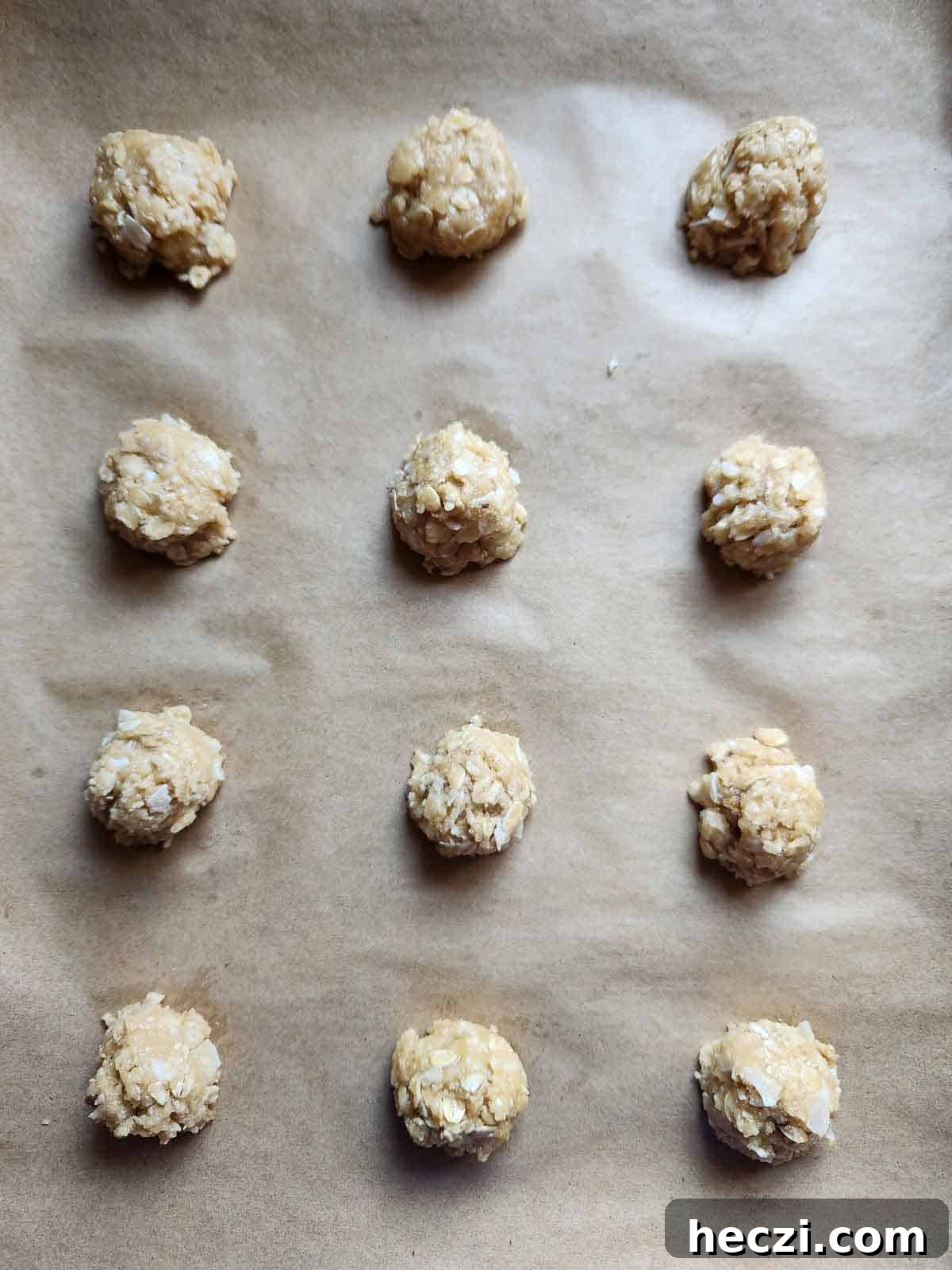 Coconut Oatmeal Cookie Recipe — Chewy Coconut Oatmeal Cookies 6 Cookie batter dropped on a parchment lined baking sheet.