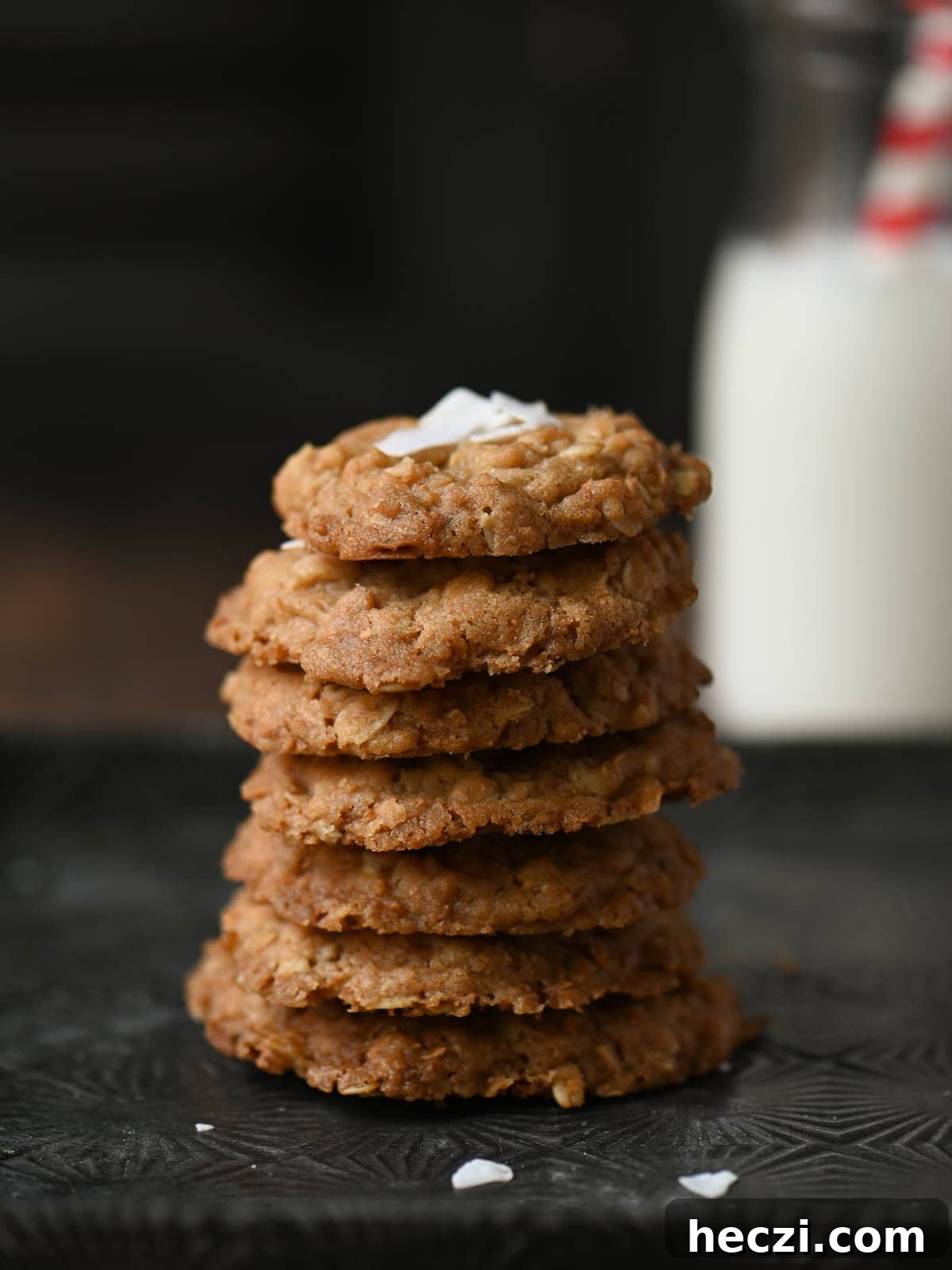 Coconut Oatmeal Cookie Recipe — Chewy Coconut Oatmeal Cookies 8 A stack of oatmeal cookies on a tin tray.