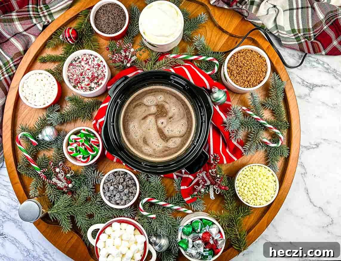 A wooden platter with hot cocoa, candy canes, and marshmallows.