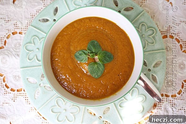 Slow Cooker Creamy Pumpkin Soup Recipe 6 An overhead photo of a bowl of pumpkin soup with fresh parsley on top.