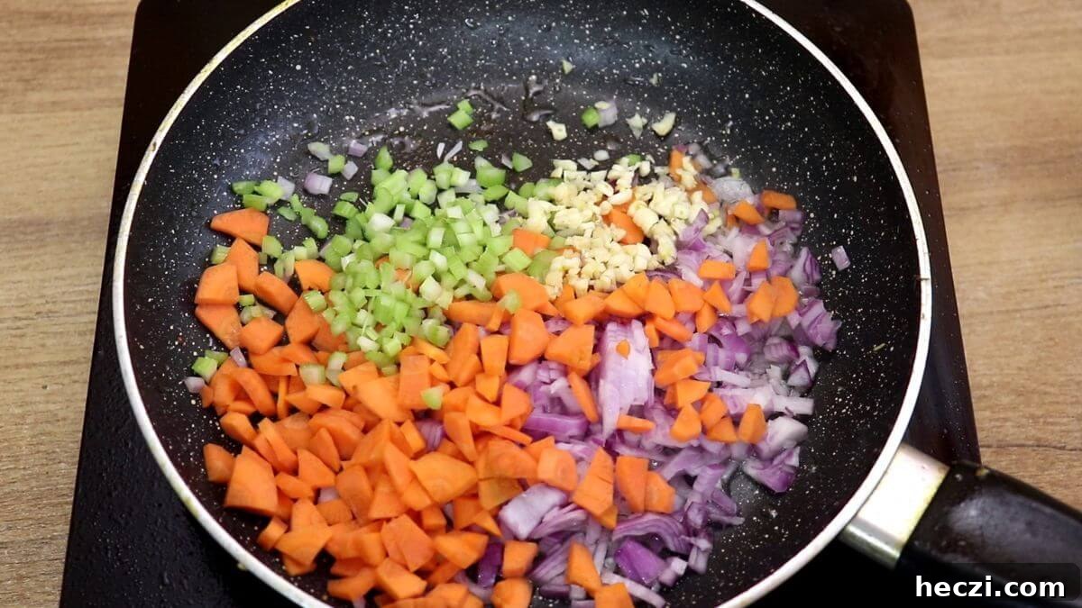 Creamy Chicken and Vegetable Stew for Comforting Weeknight Meals 7 addition of vegetables to pan for making creamy chicken stew recipe.
