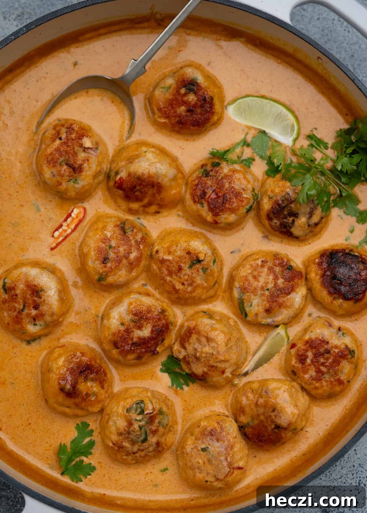 Chicken meatballs flavoured with fresh Thai herbs in a red curry sauce.