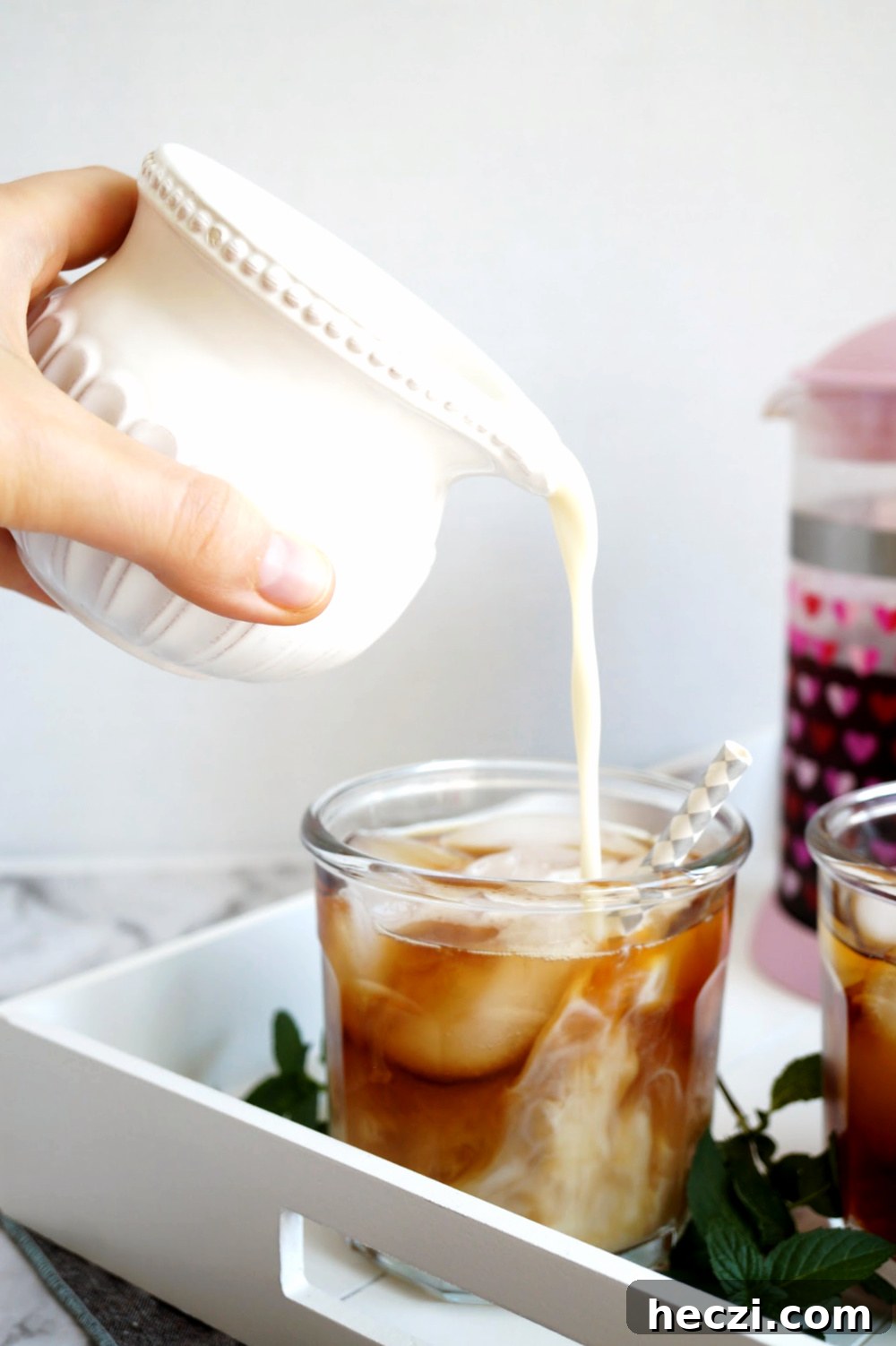 French Press Cold Brew Coffee: Smooth, Strong Cold Brew Recipe 6 pouring oat milk into the cold brew coffee