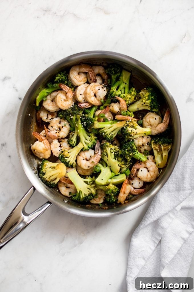Garlic Shrimp and Broccoli Rice Bowls for Quick Weeknight Meals 3 metal skillet with easy shrimp and broccoli recipe