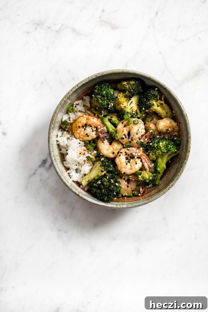 Garlic Shrimp and Broccoli Rice Bowls for Quick Weeknight Meals 4 shrimp and broccoli bowl over rice on a marble surface