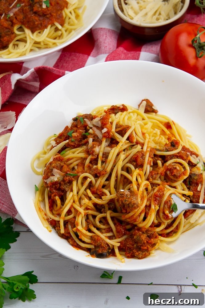Authentic Homemade Spaghetti Sauce Recipe for Rich, Classic Flavor 2 a bowl of pasta with meat tomato sauce in a white bowl