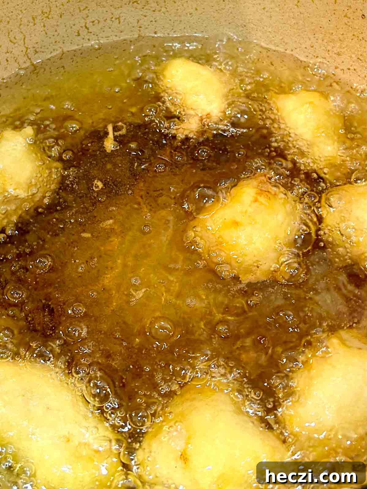 Crispy Chinese Chicken Balls in Classic Sweet and Sour Sauce 7 chicken balls being fried in hot oil