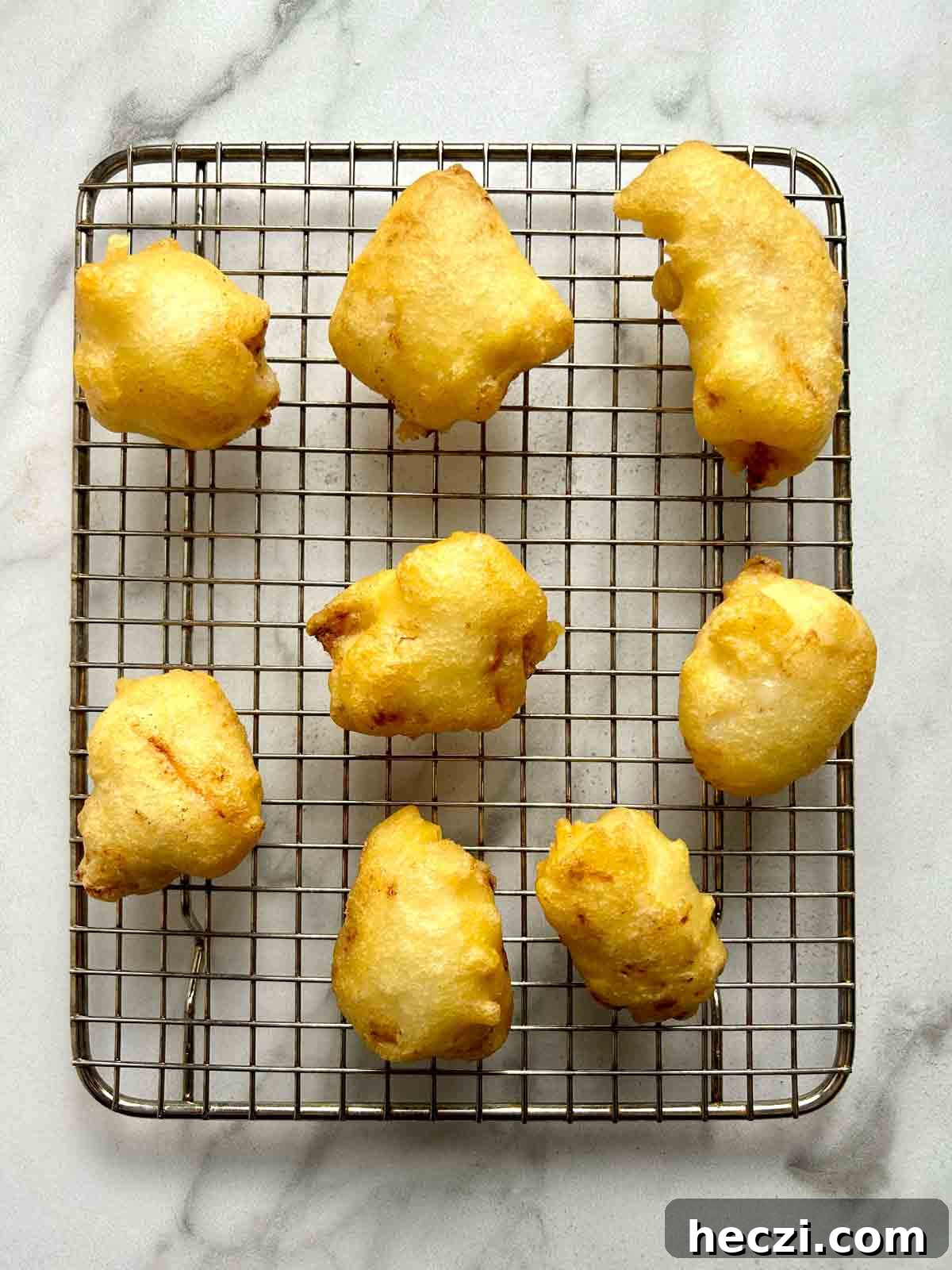 Crispy Chinese Chicken Balls in Classic Sweet and Sour Sauce 8 fried chicken balls drying on wire rack