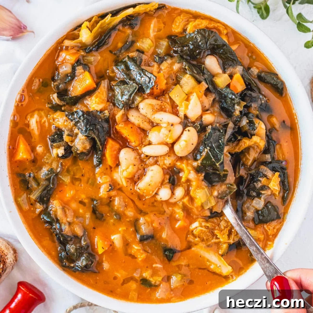 19 Budget-Friendly Bean Recipes to Save You Money Weekly 13 Tuscan white bean soup with hand and red nails