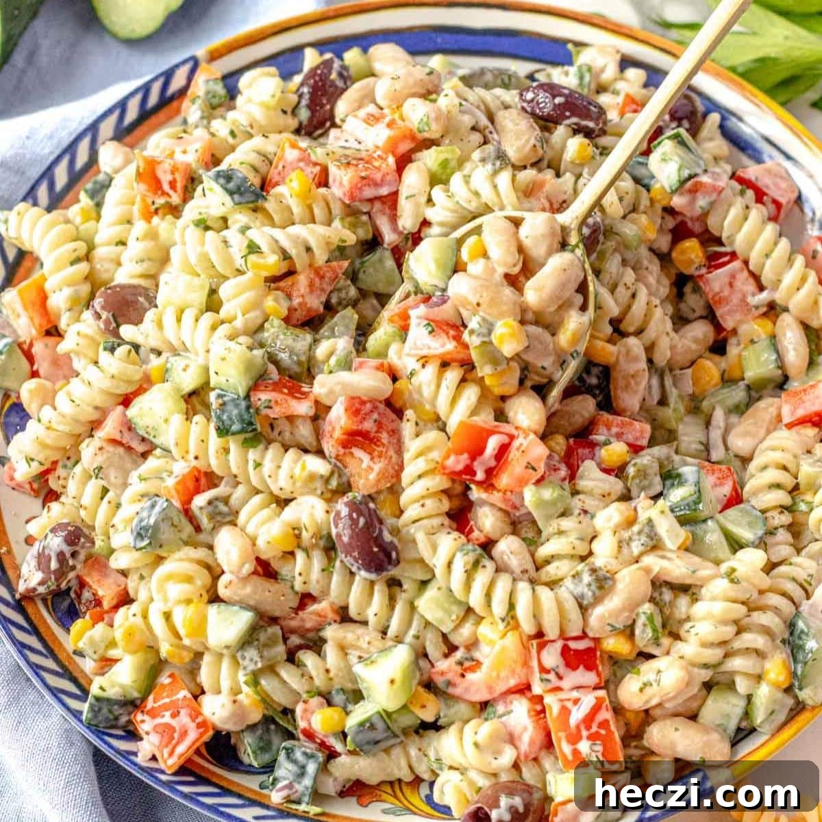 19 Budget-Friendly Bean Recipes to Save You Money Weekly 6 Creamy Greek yogurt pasta salad with beans and vegetables in a serving bowl.