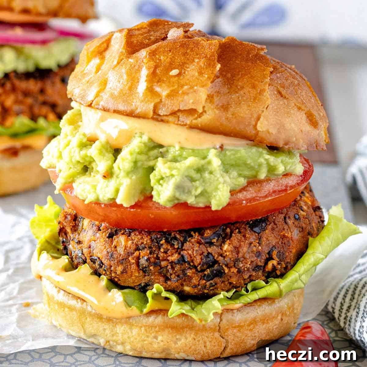 19 Budget-Friendly Bean Recipes to Save You Money Weekly 9 Black bean burger with guacamole and tomato in a bun