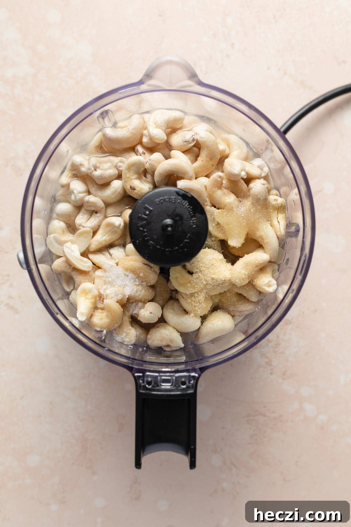 Creamy Cashew Vegan Mayo Recipe — Dairy-Free Mayonnaise 4 Cashews and other mayo ingredients in a food processor.