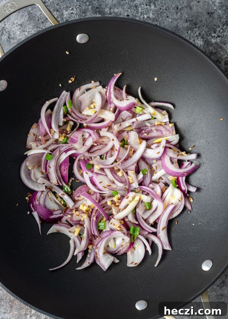 Vegetable Jalfrezi Stir-Fry Recipe: Quick Spicy Indian Veg Stir-Fry 7 overhead process shot: onions cooking in a wok