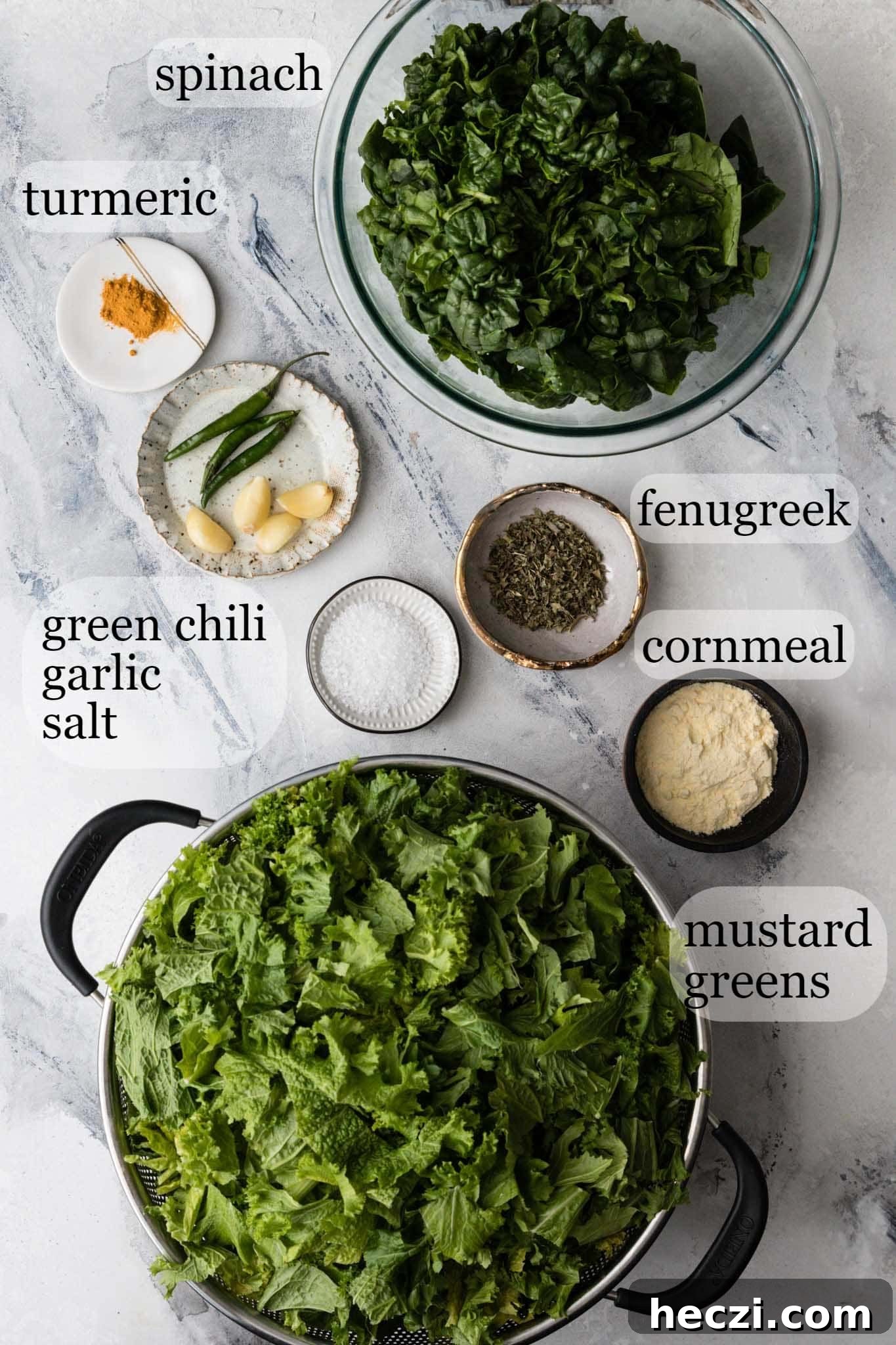 Marbled backdrop with ingredients for making Instant Pot Sarson Ka Saag 