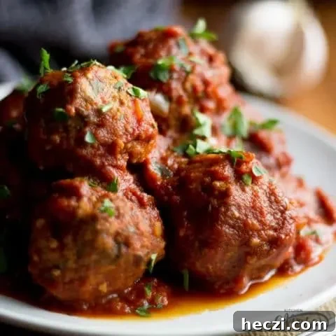Slow Cooker Meatballs on a plate with parsley scattered on top