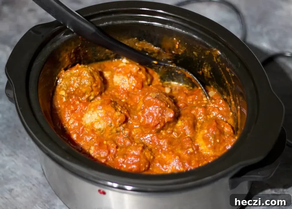Meatballs in a sauce in a slow cooker.