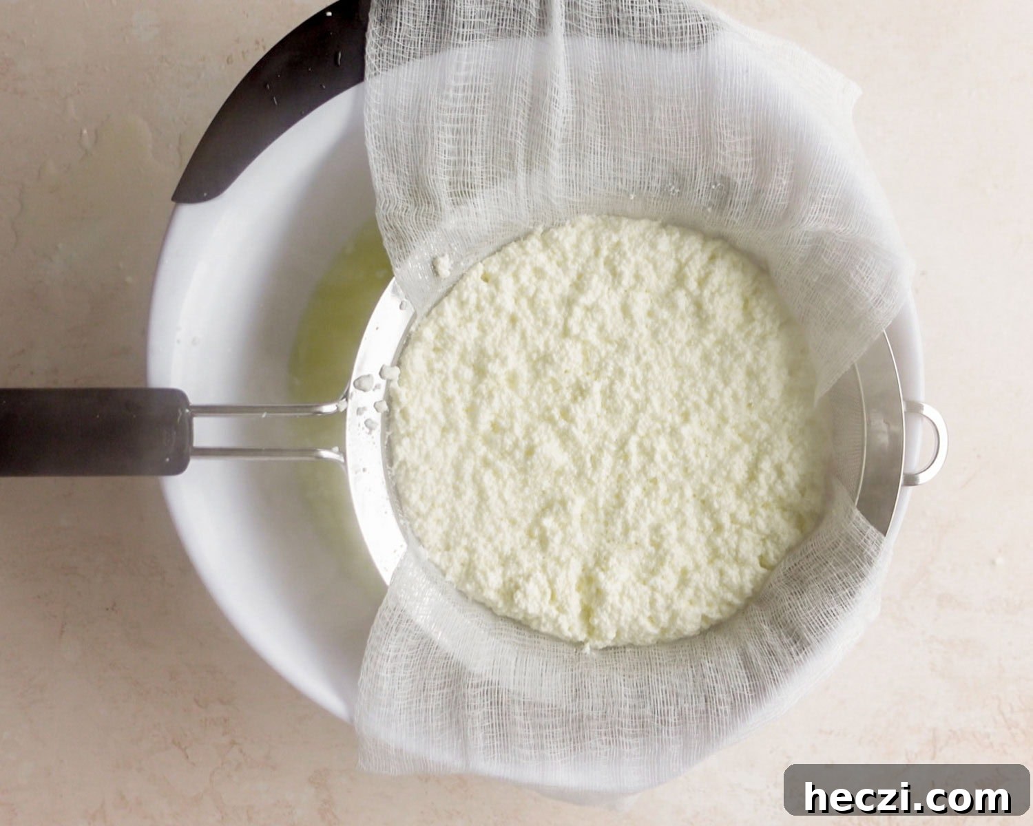 Quick Homemade Ricotta Cheese in Under 30 Minutes 18 Straining homemade ricotta using cheesecloth and a deep mixing bowl.